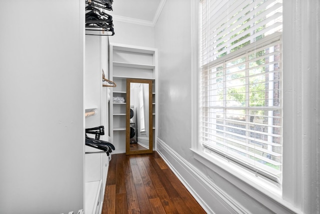 hall featuring dark wood-type flooring, crown molding, and baseboards