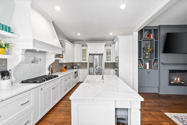 kitchen featuring appliances with stainless steel finishes, white cabinets, a sink, and open shelves