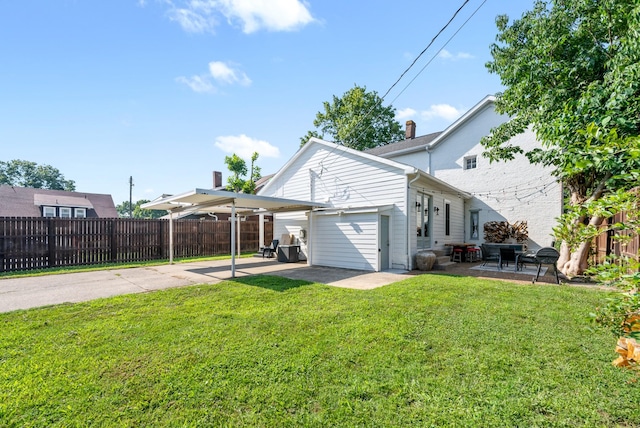 rear view of property with a patio area, fence, and a yard