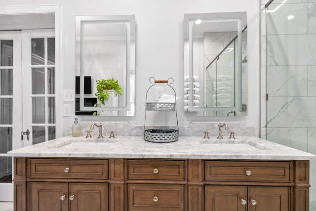 bathroom featuring double vanity, a sink, and a shower stall