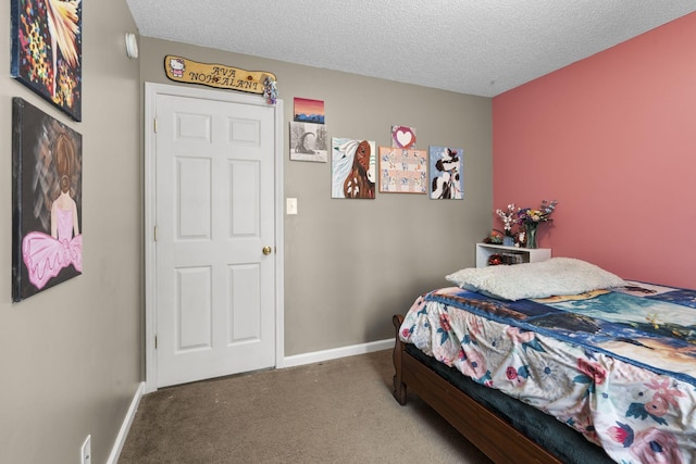 bedroom with carpet floors, baseboards, and a textured ceiling