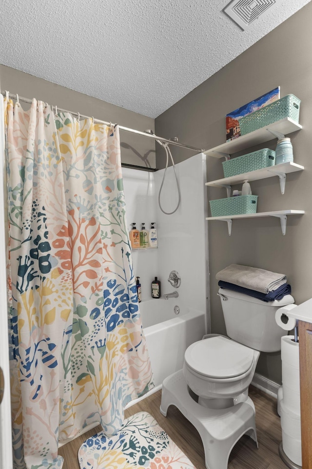 full bathroom featuring a textured ceiling, visible vents, and wood finished floors