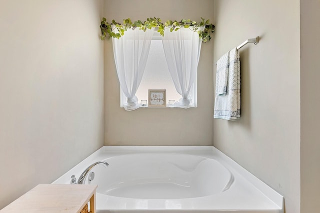 full bath featuring a garden tub and vanity