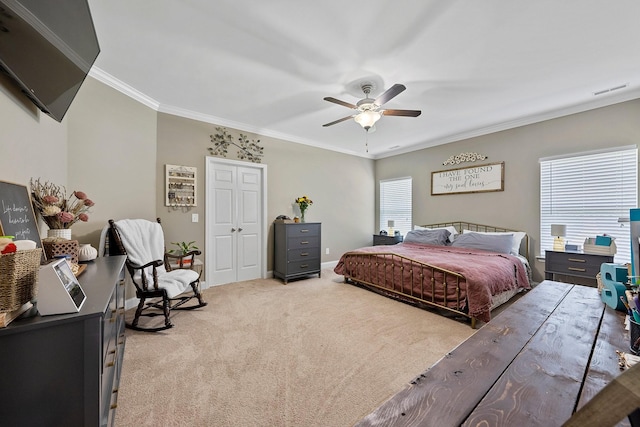 bedroom with light colored carpet, a ceiling fan, baseboards, visible vents, and ornamental molding