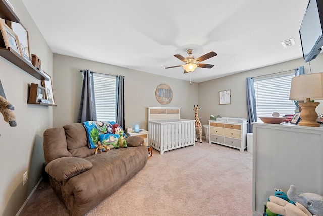 bedroom featuring baseboards, a ceiling fan, visible vents, and light colored carpet