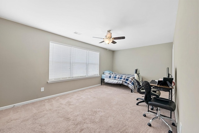 carpeted bedroom with a ceiling fan, visible vents, and baseboards