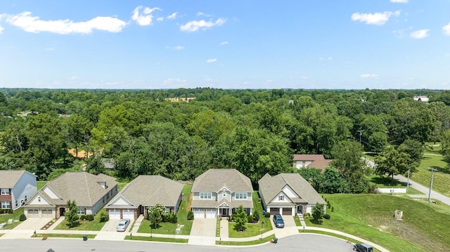 birds eye view of property featuring a residential view and a view of trees