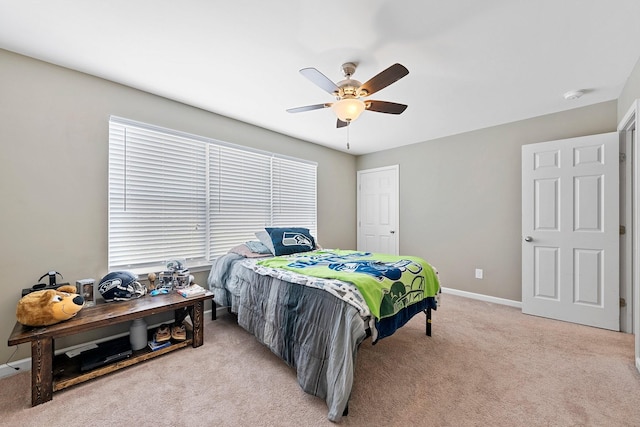 bedroom featuring light carpet, ceiling fan, and baseboards