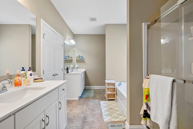 full bathroom with a shower stall, visible vents, two vanities, and a sink