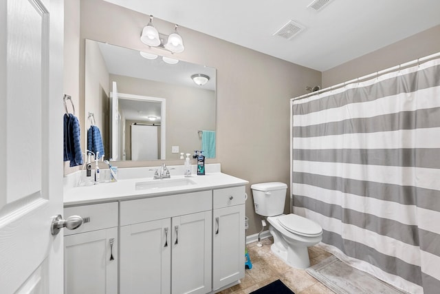 bathroom featuring toilet, baseboards, visible vents, and vanity