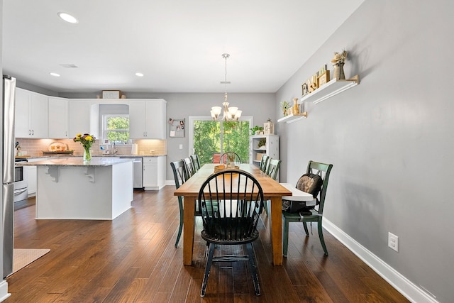 dining space featuring a chandelier, recessed lighting, dark wood-style flooring, and baseboards