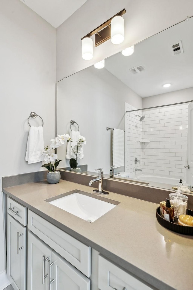 full bath with bathtub / shower combination, visible vents, and vanity