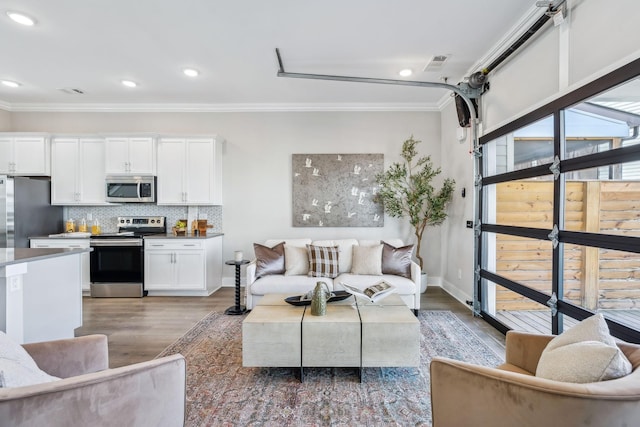 living area with a garage, ornamental molding, and dark wood-style flooring