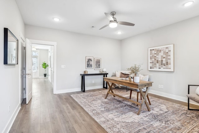 home office featuring recessed lighting, ceiling fan, light wood-style flooring, and baseboards