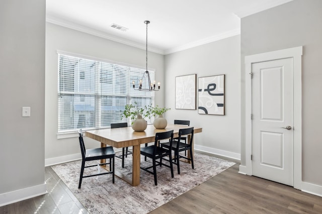 dining area with baseboards, ornamental molding, and dark wood-type flooring