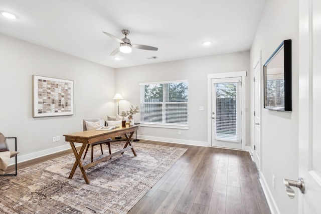 office area featuring visible vents, wood finished floors, a ceiling fan, and baseboards