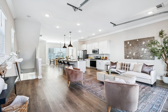 living room featuring crown molding, recessed lighting, visible vents, and dark wood finished floors