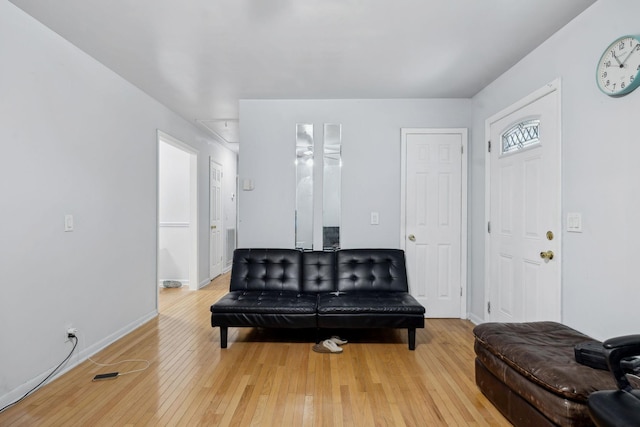 sitting room with attic access, light wood-type flooring, visible vents, and baseboards