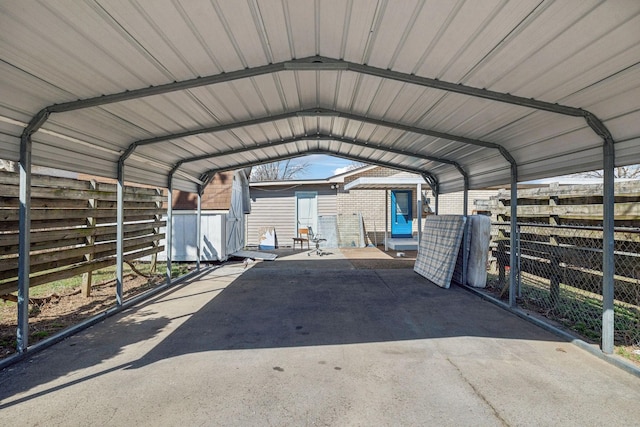 view of car parking featuring a carport and fence