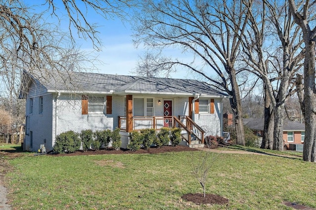 view of front of home featuring covered porch, a front lawn, and brick siding