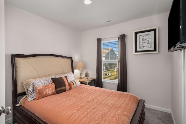 bedroom with carpet, visible vents, and baseboards