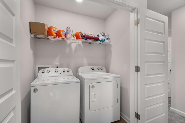 laundry room featuring laundry area, baseboards, and separate washer and dryer