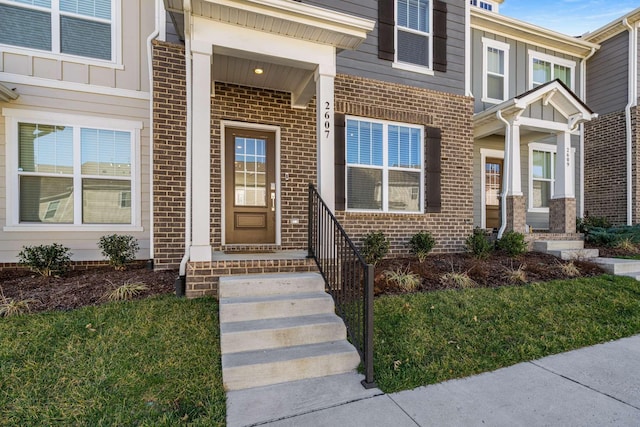 entrance to property featuring brick siding