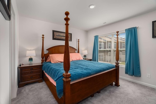 bedroom featuring baseboards and light colored carpet