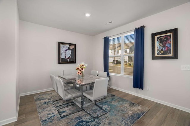 dining space with visible vents, baseboards, wood finished floors, and recessed lighting