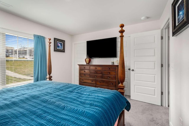 carpeted bedroom featuring visible vents