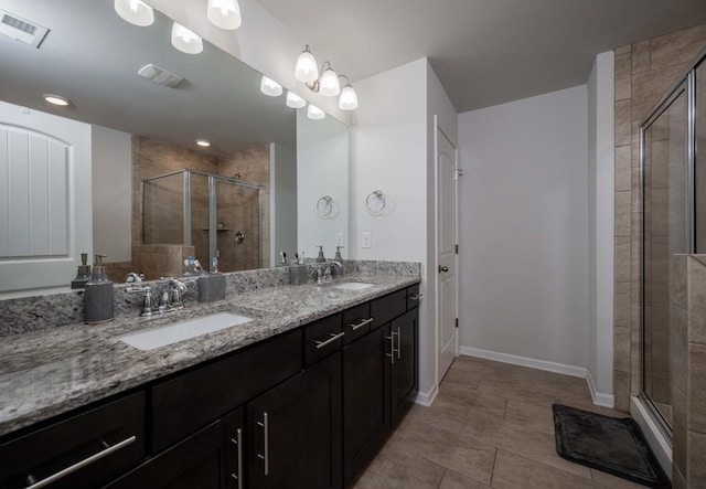 full bath featuring visible vents, a sink, and a shower stall