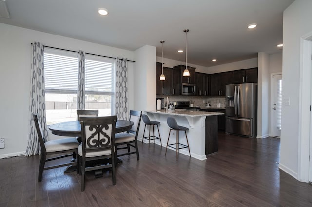 dining room featuring recessed lighting, dark wood-style flooring, and baseboards