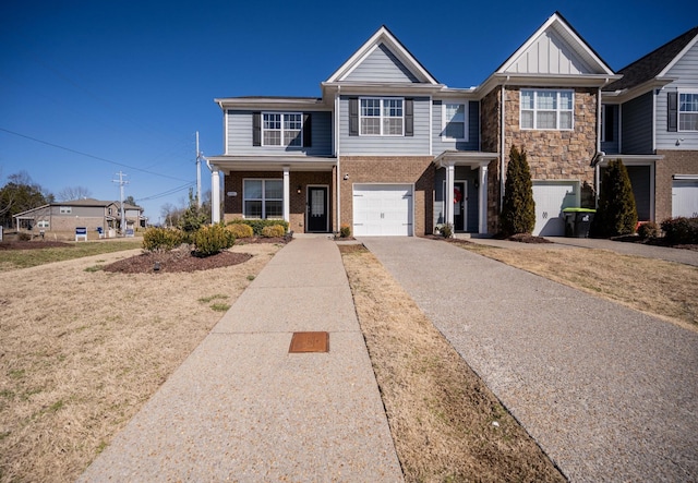 view of front of property with aphalt driveway, board and batten siding, an attached garage, and brick siding