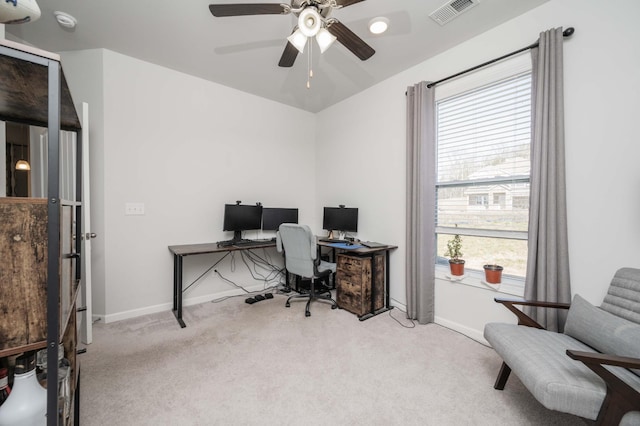 office featuring baseboards, a ceiling fan, visible vents, and light colored carpet