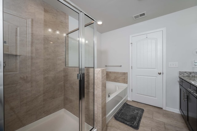 full bath with a garden tub, vanity, visible vents, tile patterned floors, and a stall shower