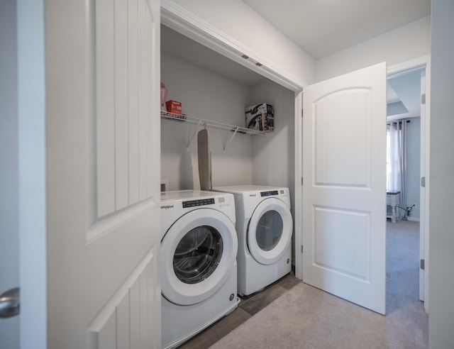 laundry room featuring laundry area, washing machine and dryer, and light colored carpet