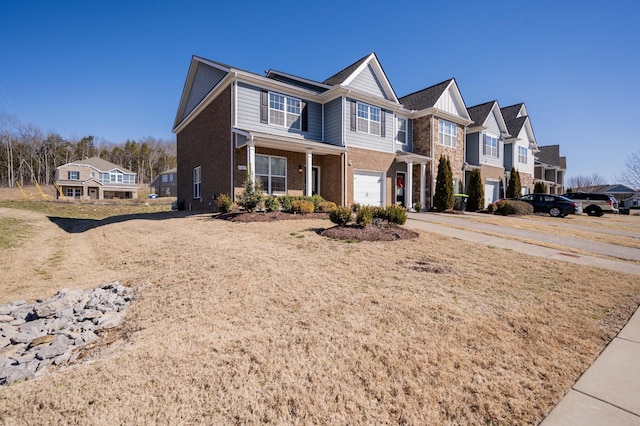 view of front facade featuring a residential view, brick siding, driveway, and an attached garage