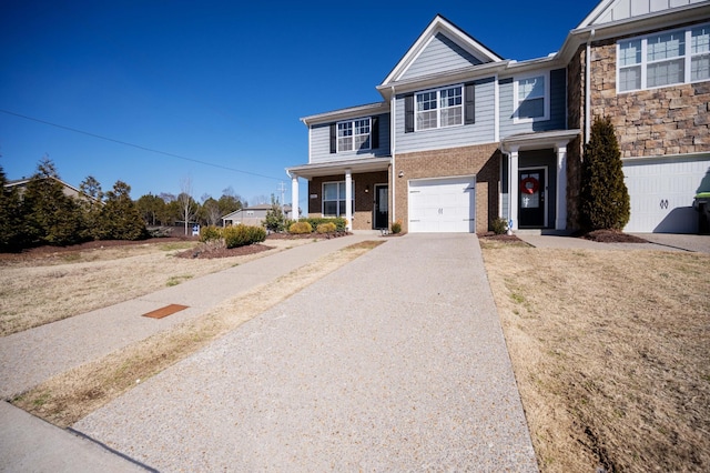 view of front of property featuring an attached garage, a porch, aphalt driveway, and brick siding