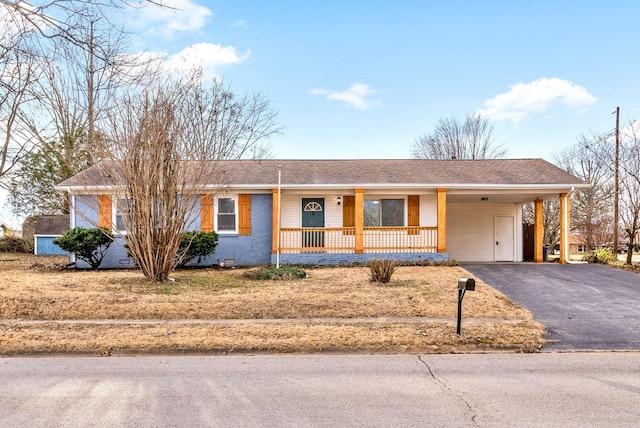 ranch-style home with driveway, a shingled roof, an attached carport, crawl space, and covered porch