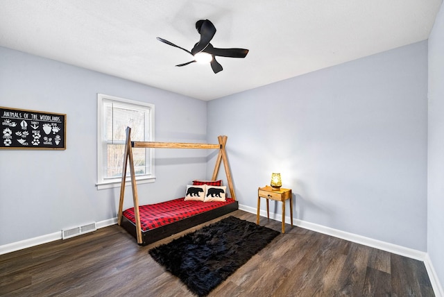 bedroom with a ceiling fan, dark wood finished floors, visible vents, and baseboards