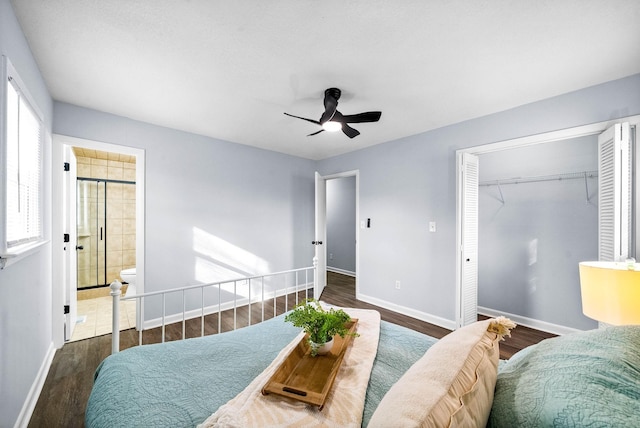 bedroom featuring multiple windows, baseboards, and dark wood-style flooring