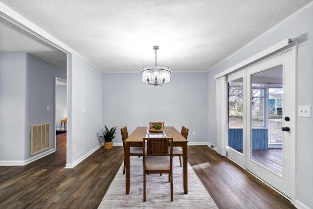 dining room featuring baseboards, a notable chandelier, visible vents, and dark wood-style flooring