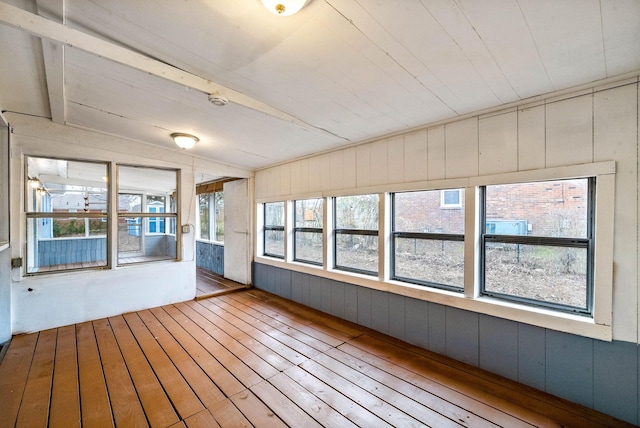 unfurnished sunroom with lofted ceiling