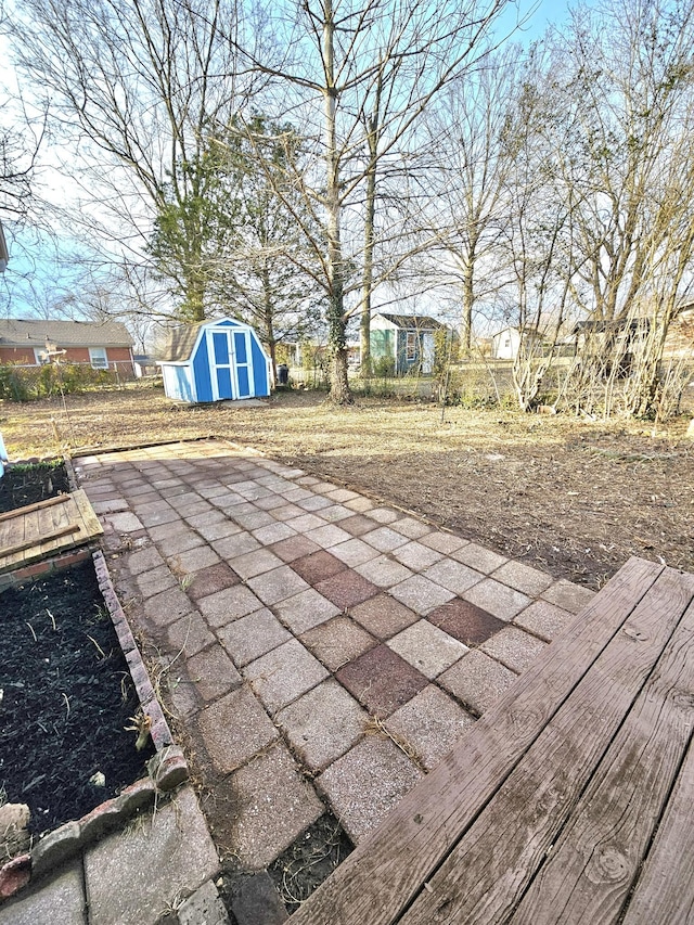 view of patio / terrace with a storage shed and an outdoor structure