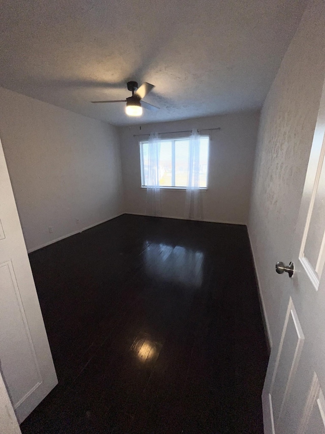 unfurnished room featuring ceiling fan, a textured ceiling, and wood finished floors