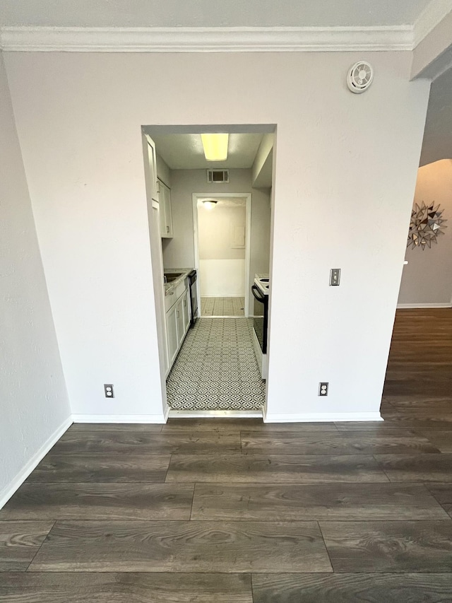 interior space with white range with electric stovetop, white cabinetry, dark wood finished floors, and visible vents