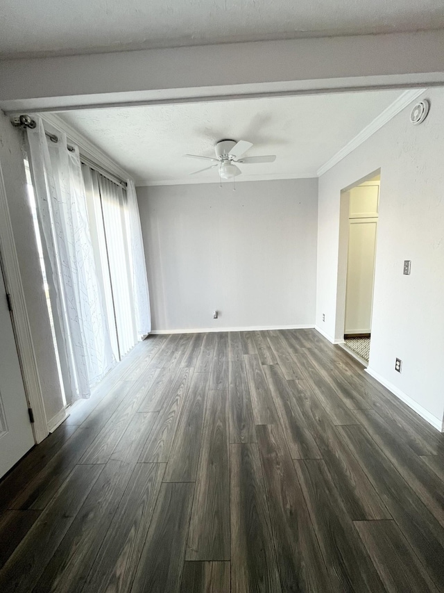 spare room with ceiling fan, ornamental molding, dark wood-style flooring, and baseboards