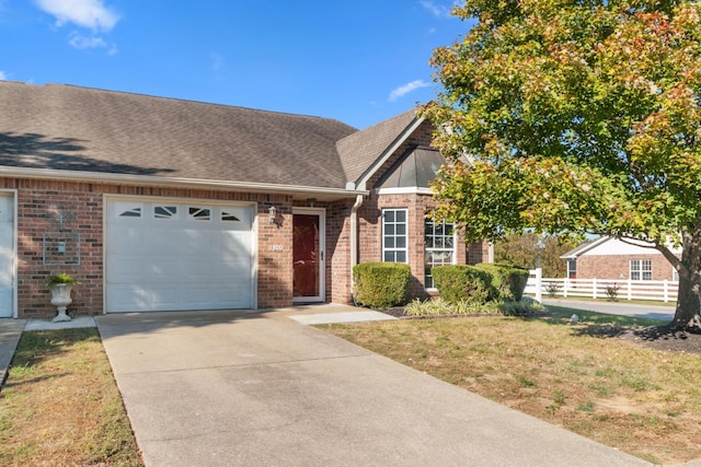 view of front of property with a garage, brick siding, roof with shingles, and fence