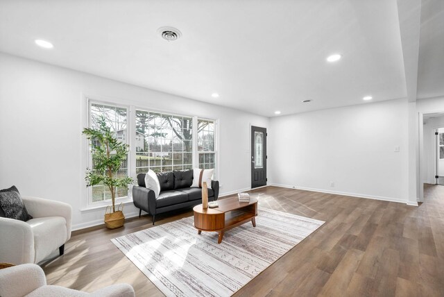 interior space with recessed lighting, visible vents, baseboards, and wood finished floors