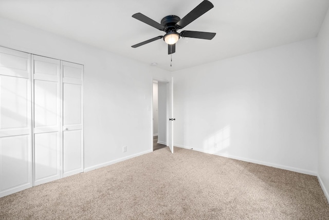 unfurnished bedroom with a ceiling fan, a closet, carpet flooring, and baseboards